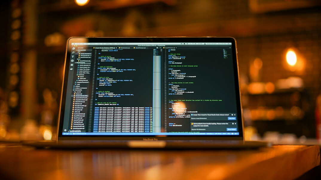developer coding on laptop